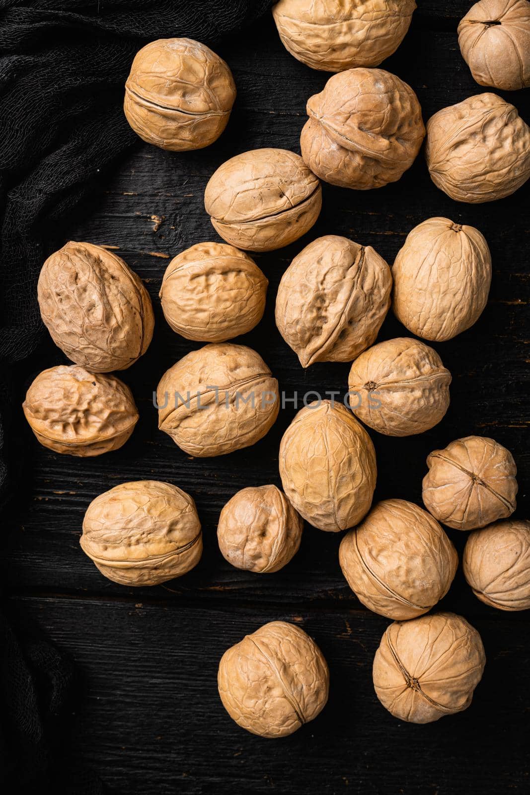 Natural walnut , on black wooden table background, top view flat lay by Ilianesolenyi