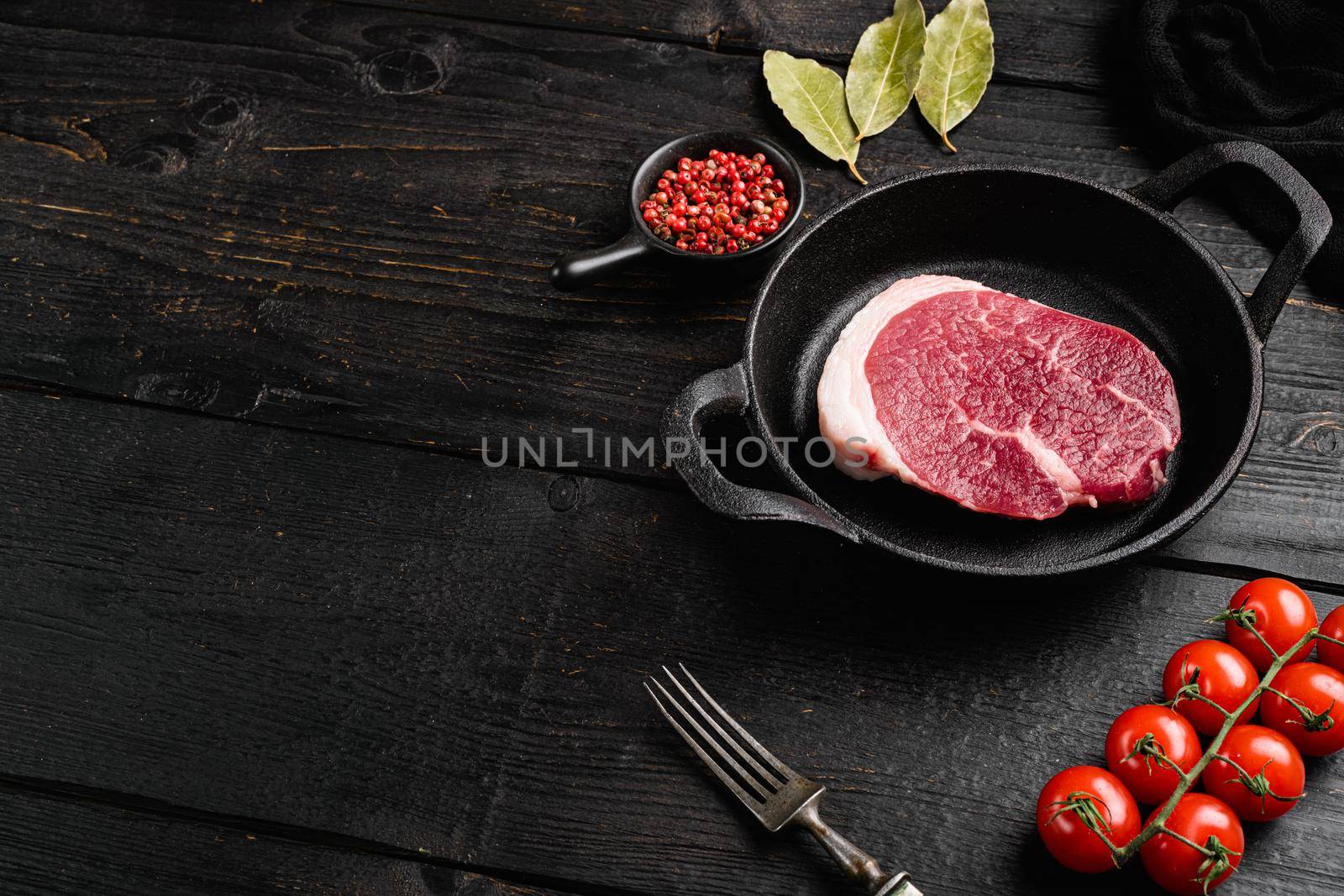 Fresh beef steak sliced, on black wooden table background, with copy space for text by Ilianesolenyi