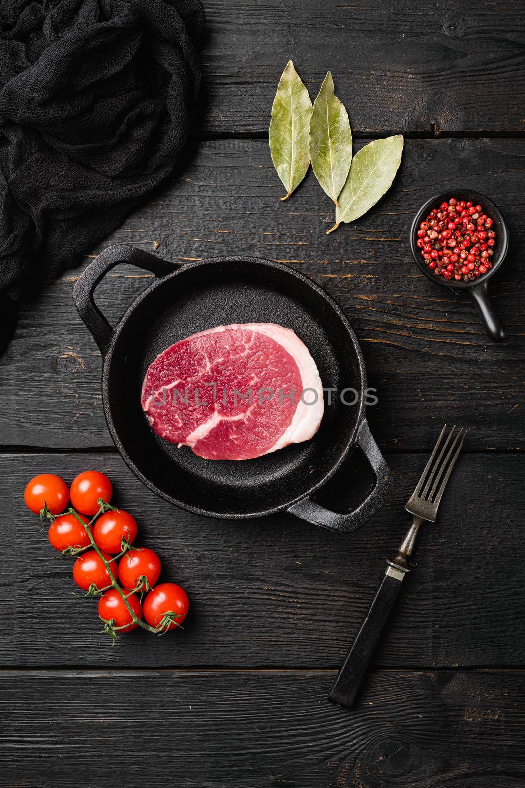 Raw beef steak set, on black wooden table background, top view flat lay