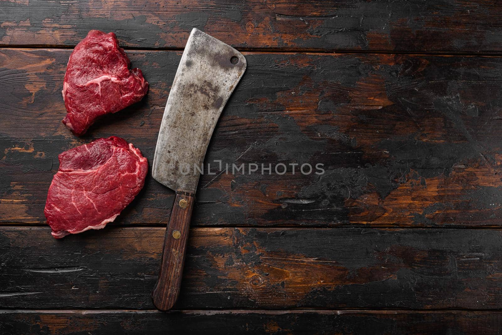 Beef raw rump steak with salt pepper rosemary, on old dark wooden table background, top view flat lay, with copy space for text by Ilianesolenyi