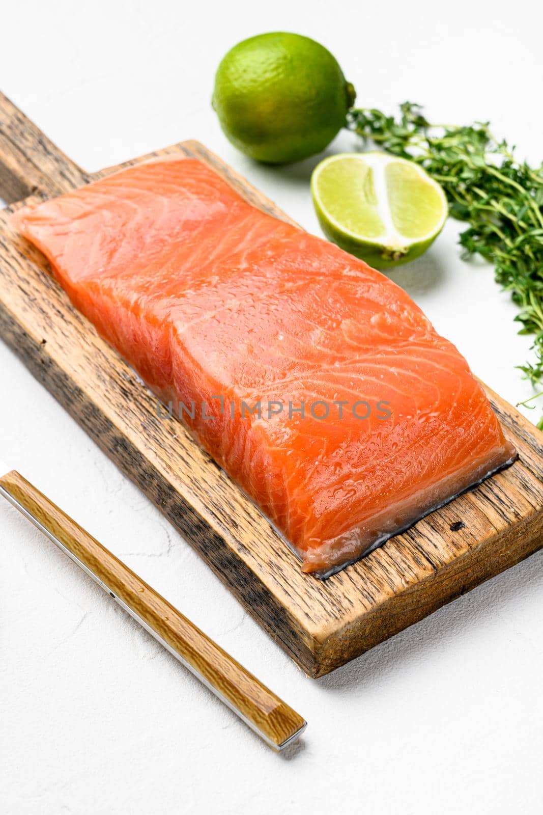 Fresh raw salmon fillet set, with herbs, on white stone table background