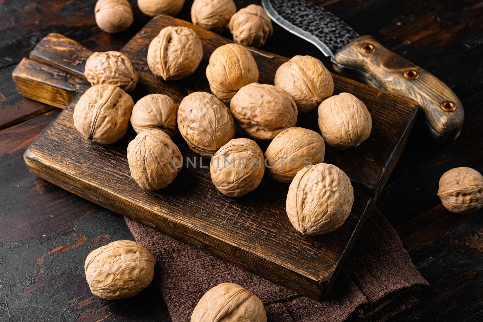 Walnut whole nut set, on old dark wooden table background