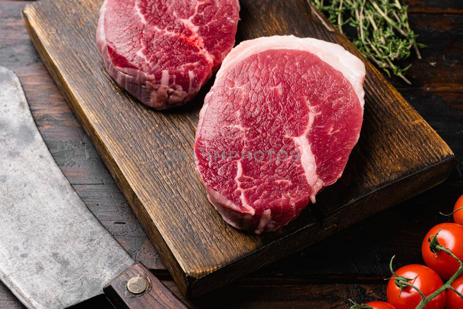 Fresh raw organic beef steak set, on old dark wooden table background