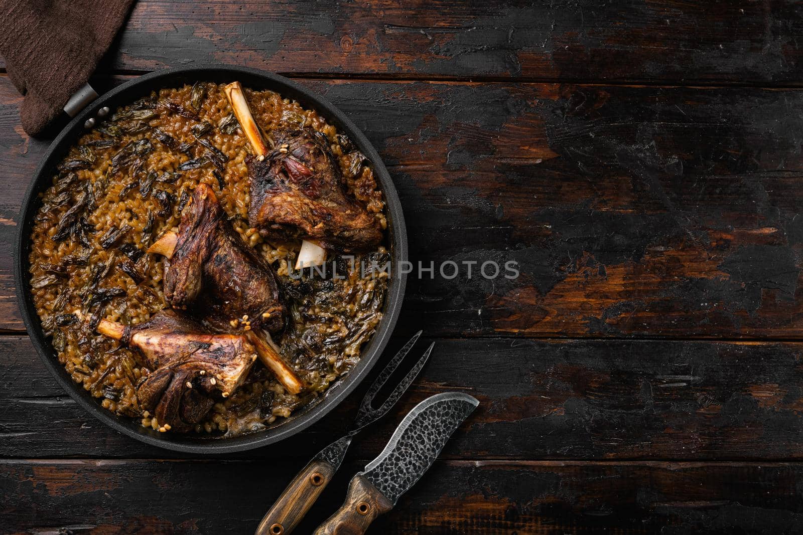 Baked whole lamb shanks meat, on old dark wooden table background, top view flat lay, with copy space for text by Ilianesolenyi