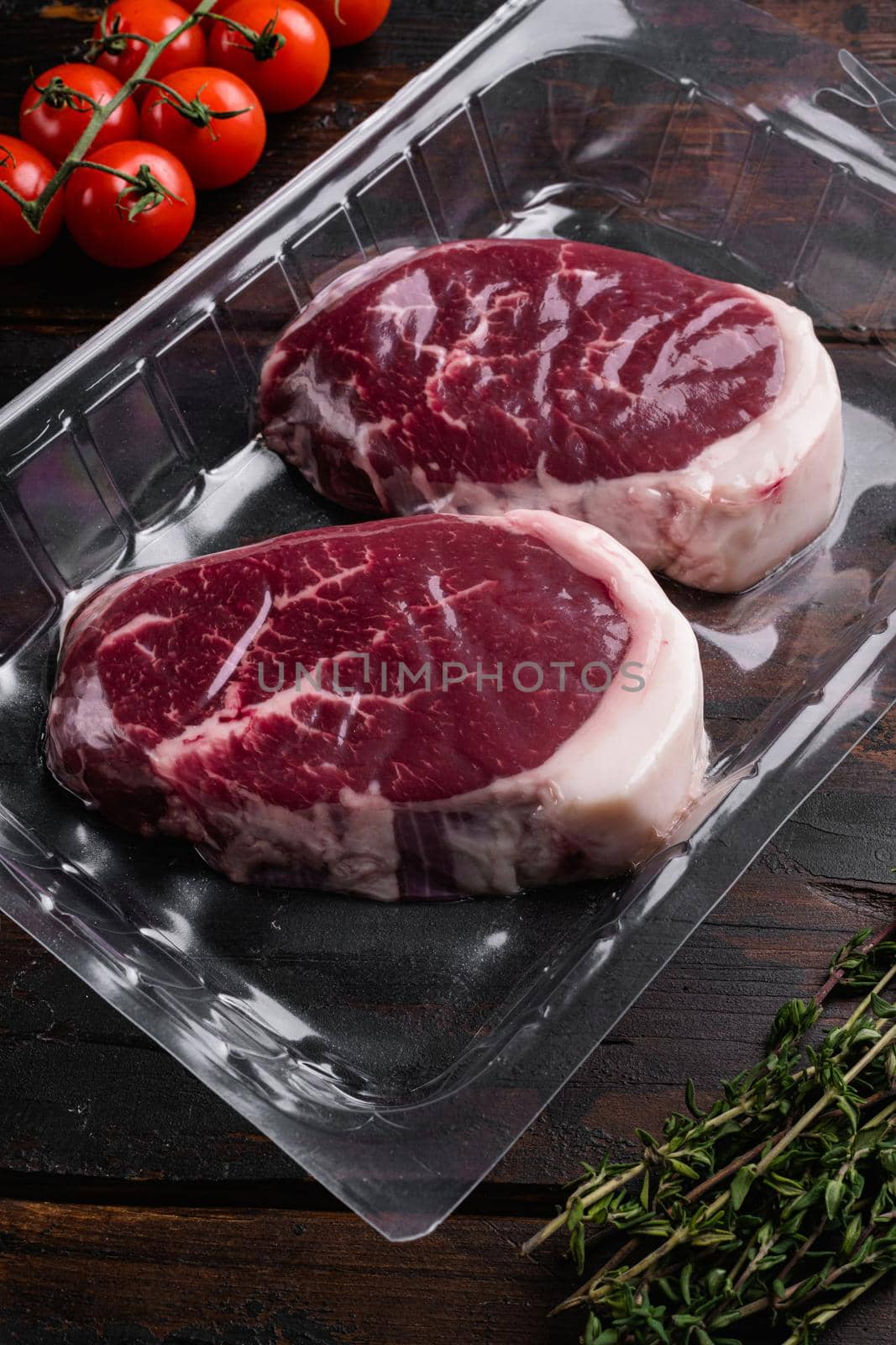 Beef steak pack, on old dark wooden table background by Ilianesolenyi