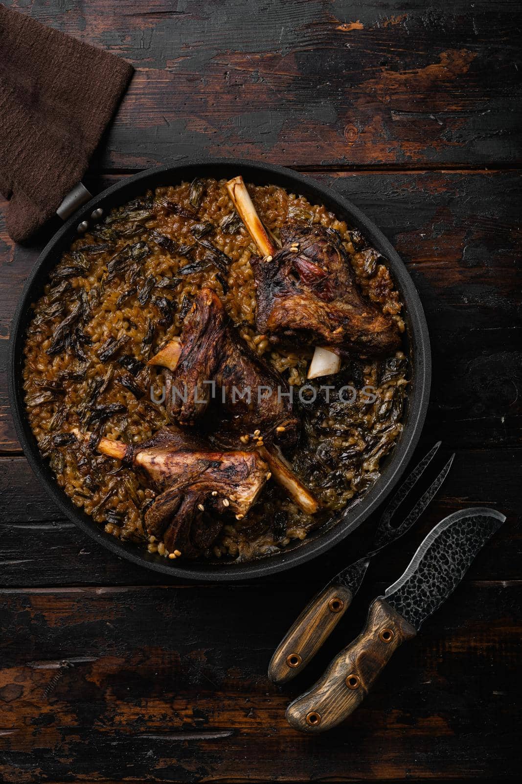 Baked lamb shank meat, on old dark wooden table background, top view flat lay by Ilianesolenyi