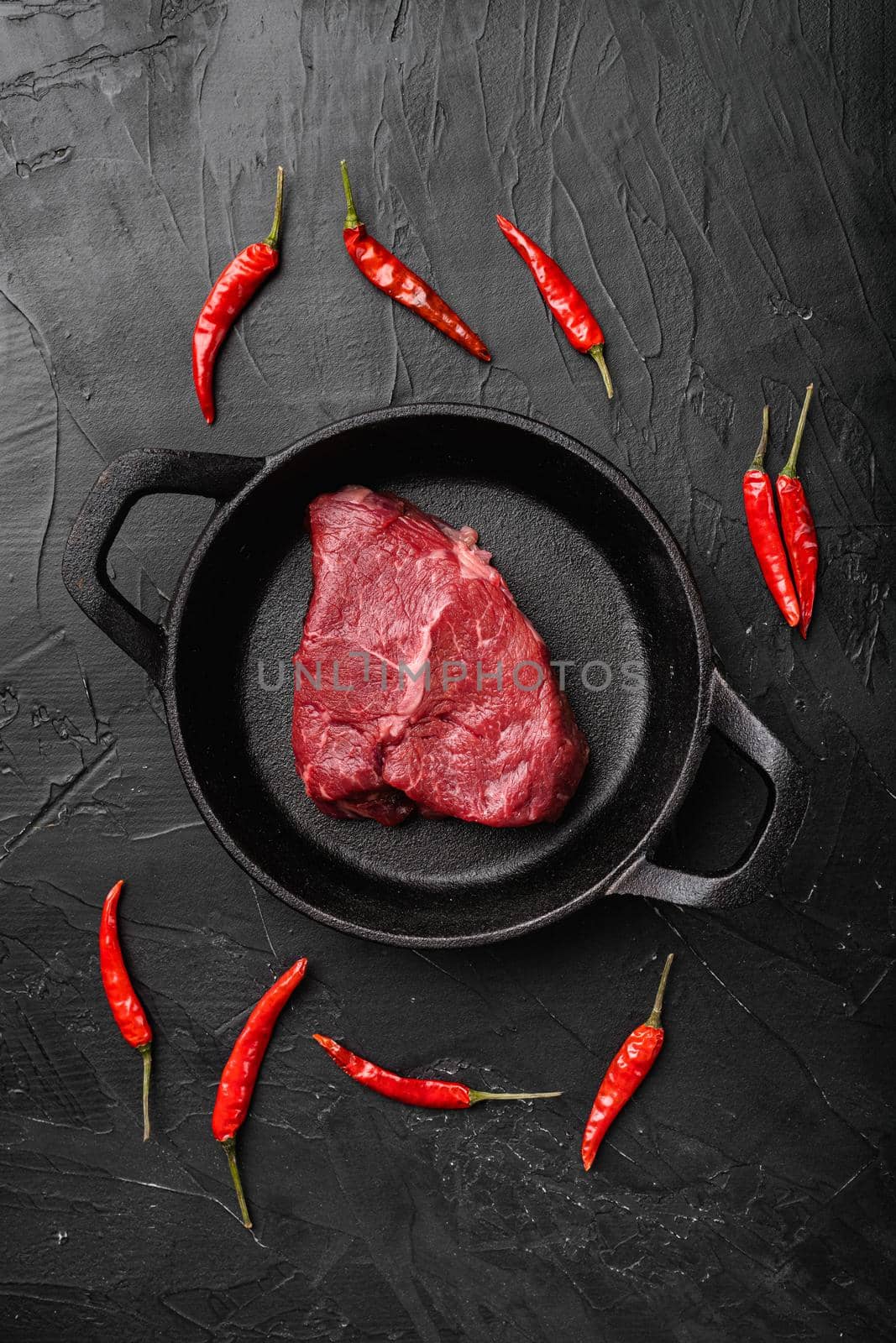 Beef rump meat steak, on black dark stone table background, top view flat lay by Ilianesolenyi