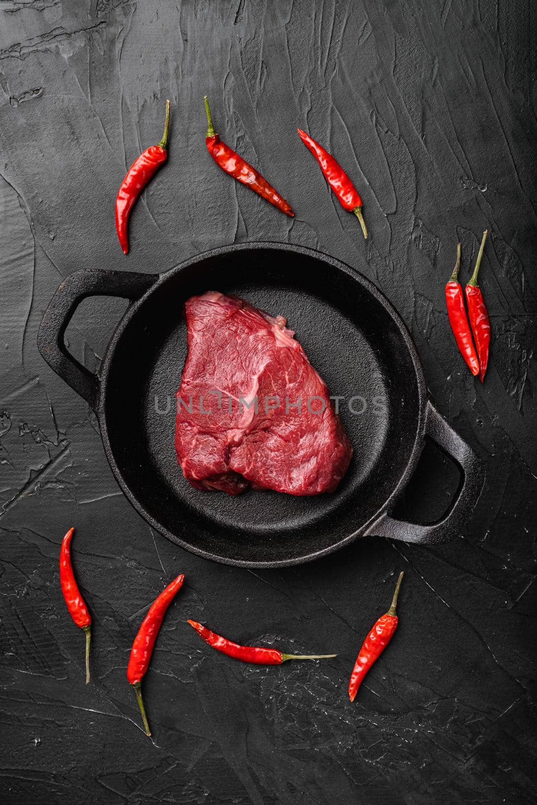 Beef rump meat steak set, on black dark stone table background, top view flat lay