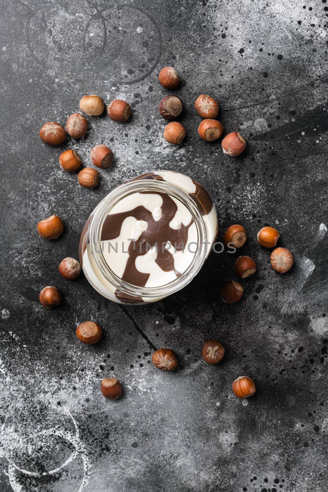 Chocolate Hazelnut Spread, on black dark stone table background, top view flat lay by Ilianesolenyi