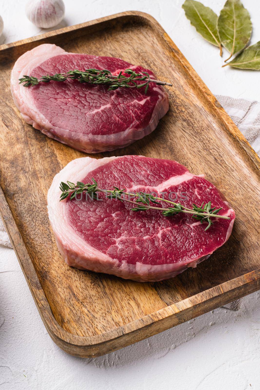 Fresh beef steak sliced, on white stone table background by Ilianesolenyi