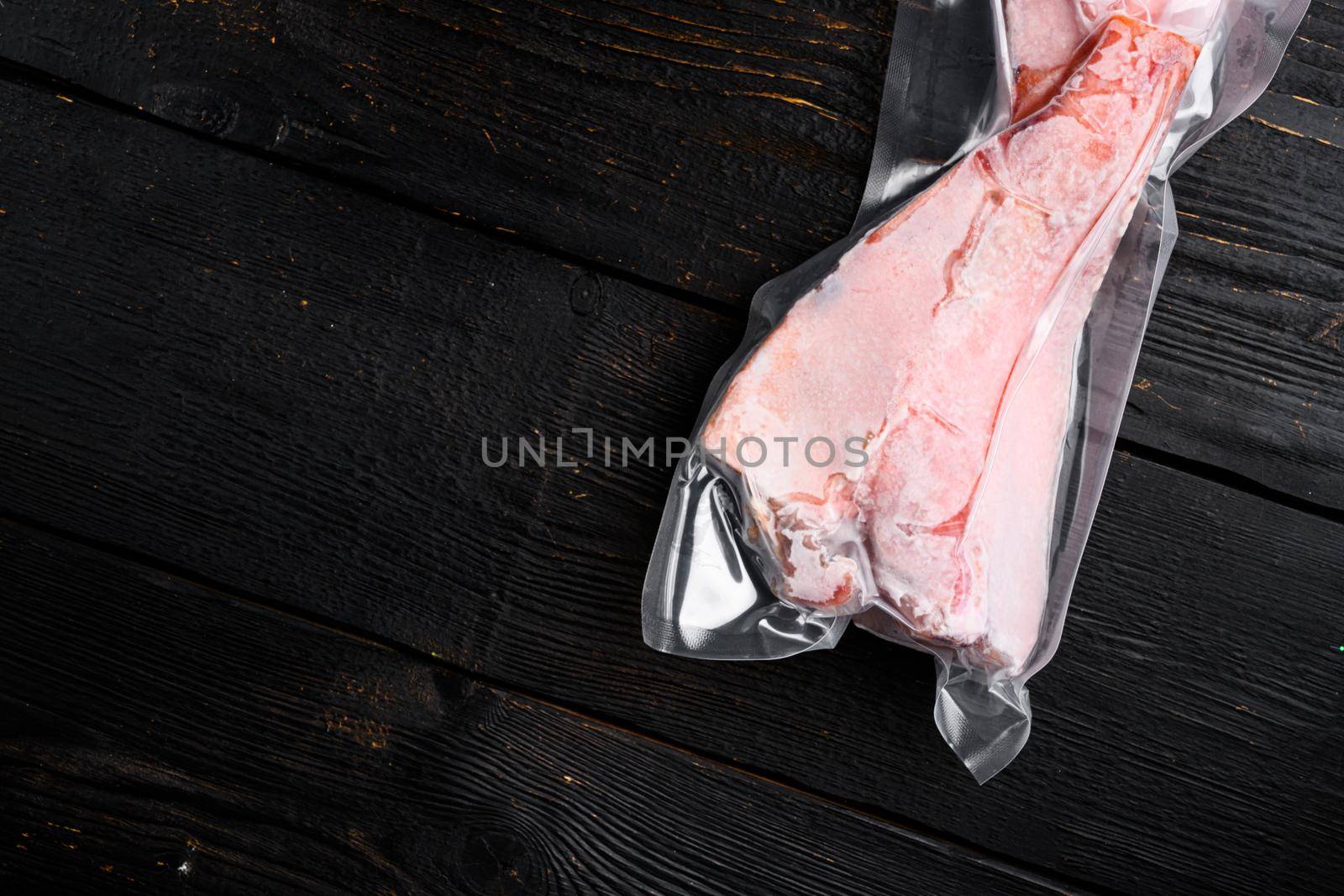 Organic fish sea perch frozen, on black wooden table background, top view flat lay, with copy space for text by Ilianesolenyi