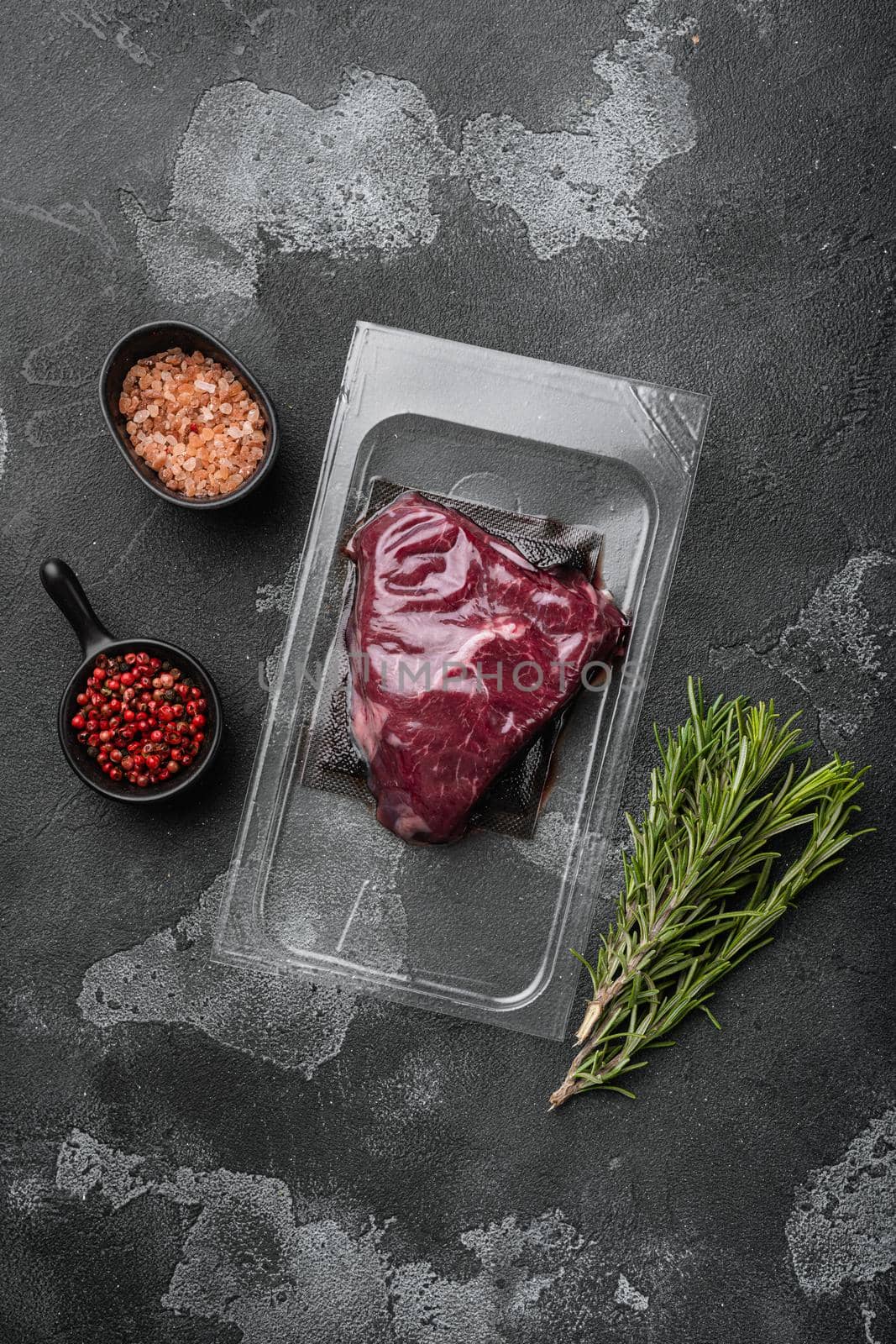 Beef rump steak pack set, on black dark stone table background, top view flat lay