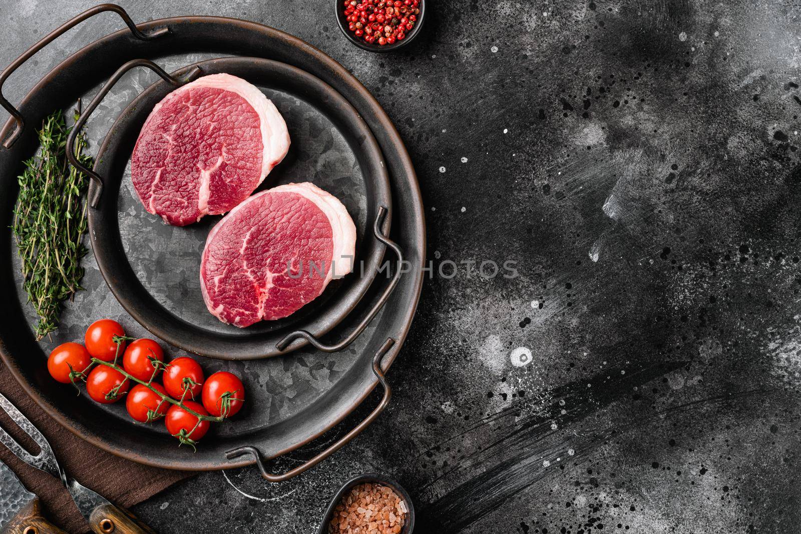 Fresh beef steak sliced set, on black dark stone table background, top view flat lay, with copy space for text