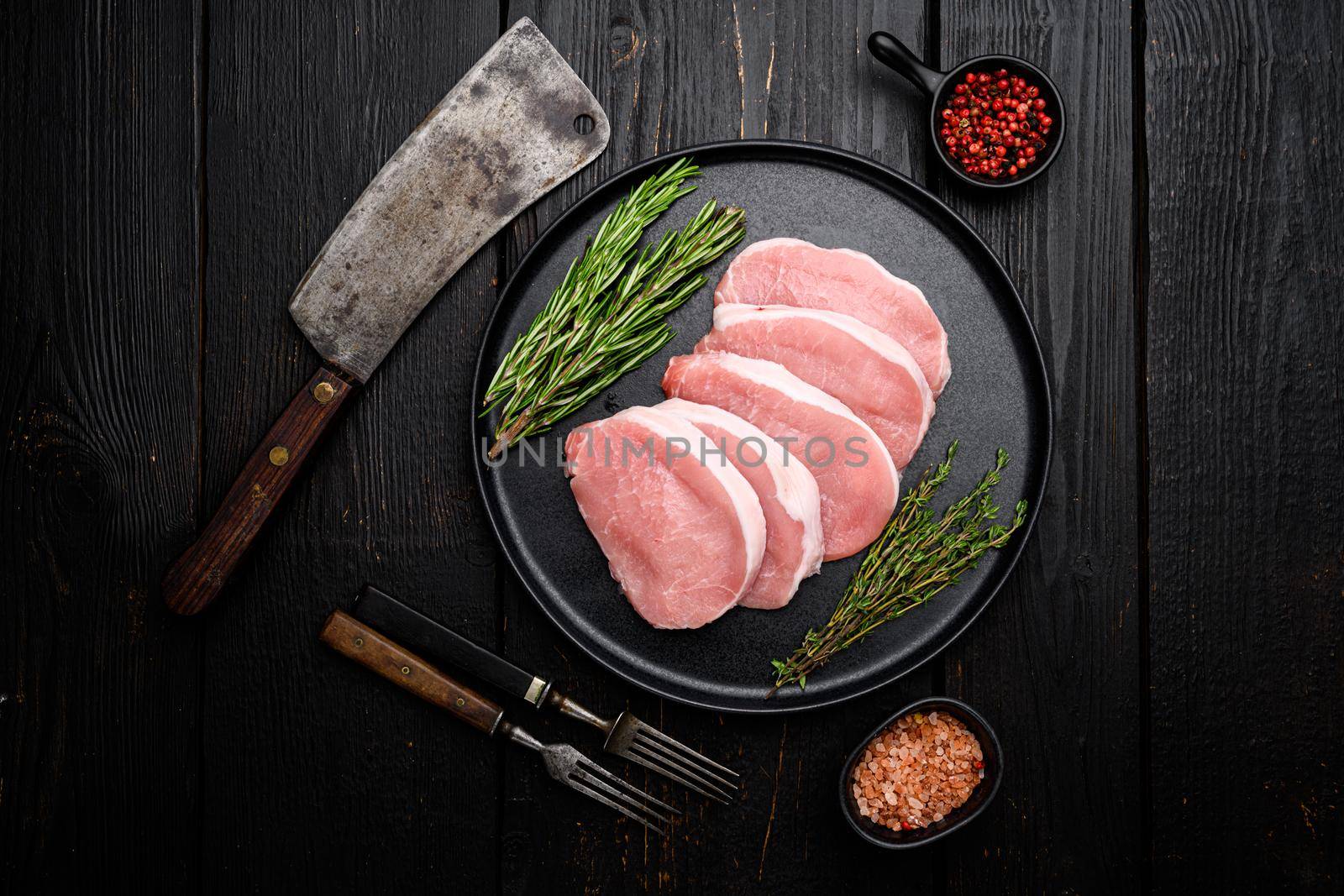 Sliced raw pork meat set, on black wooden table background, top view flat lay