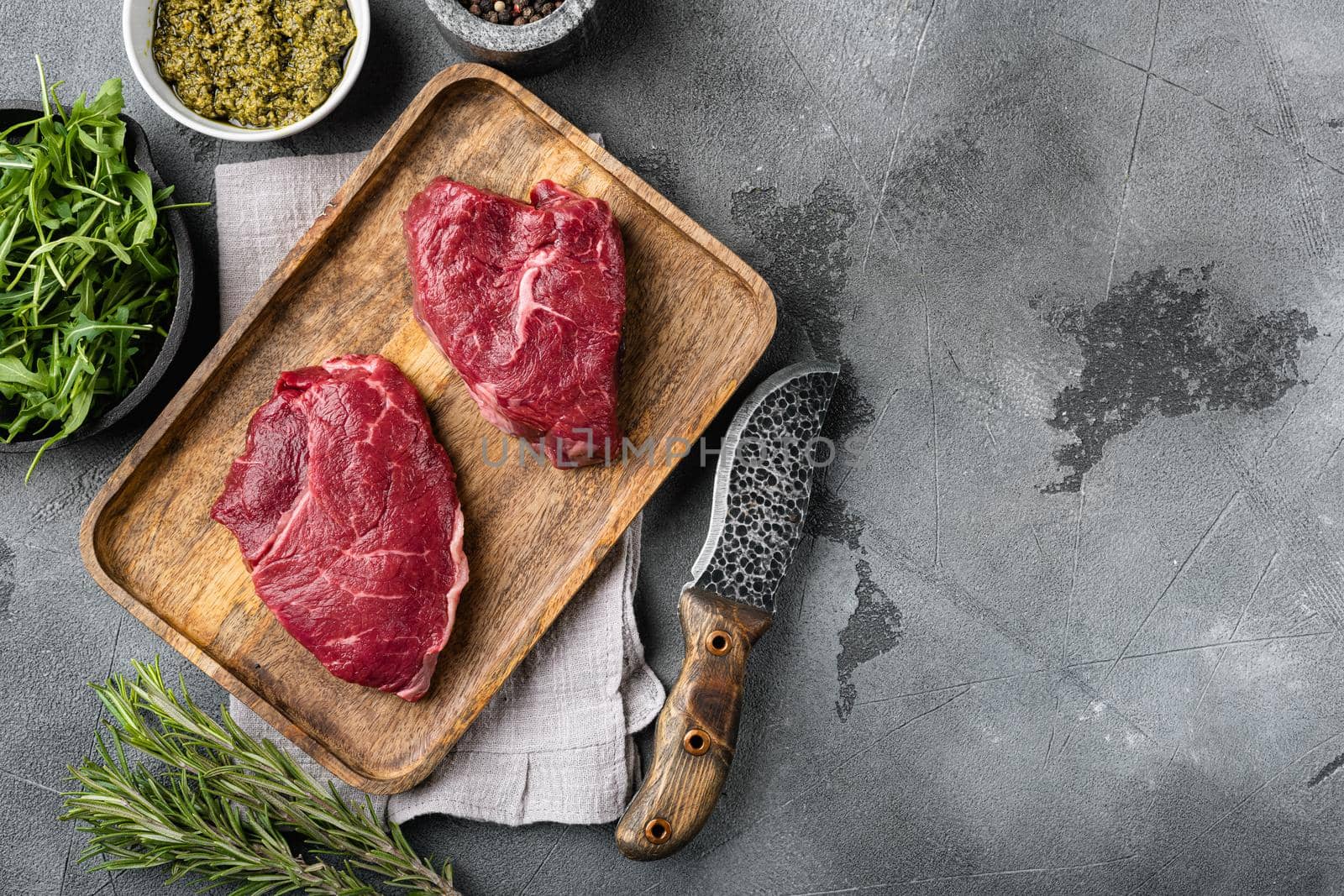Beef rump meat steak set, on gray stone table background, top view flat lay, with copy space for text