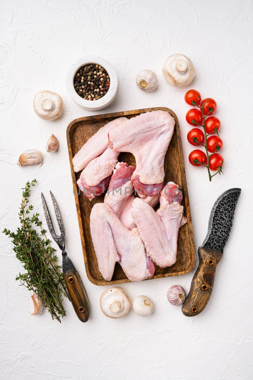 Raw turkey wings set, on white stone table background, top view flat lay