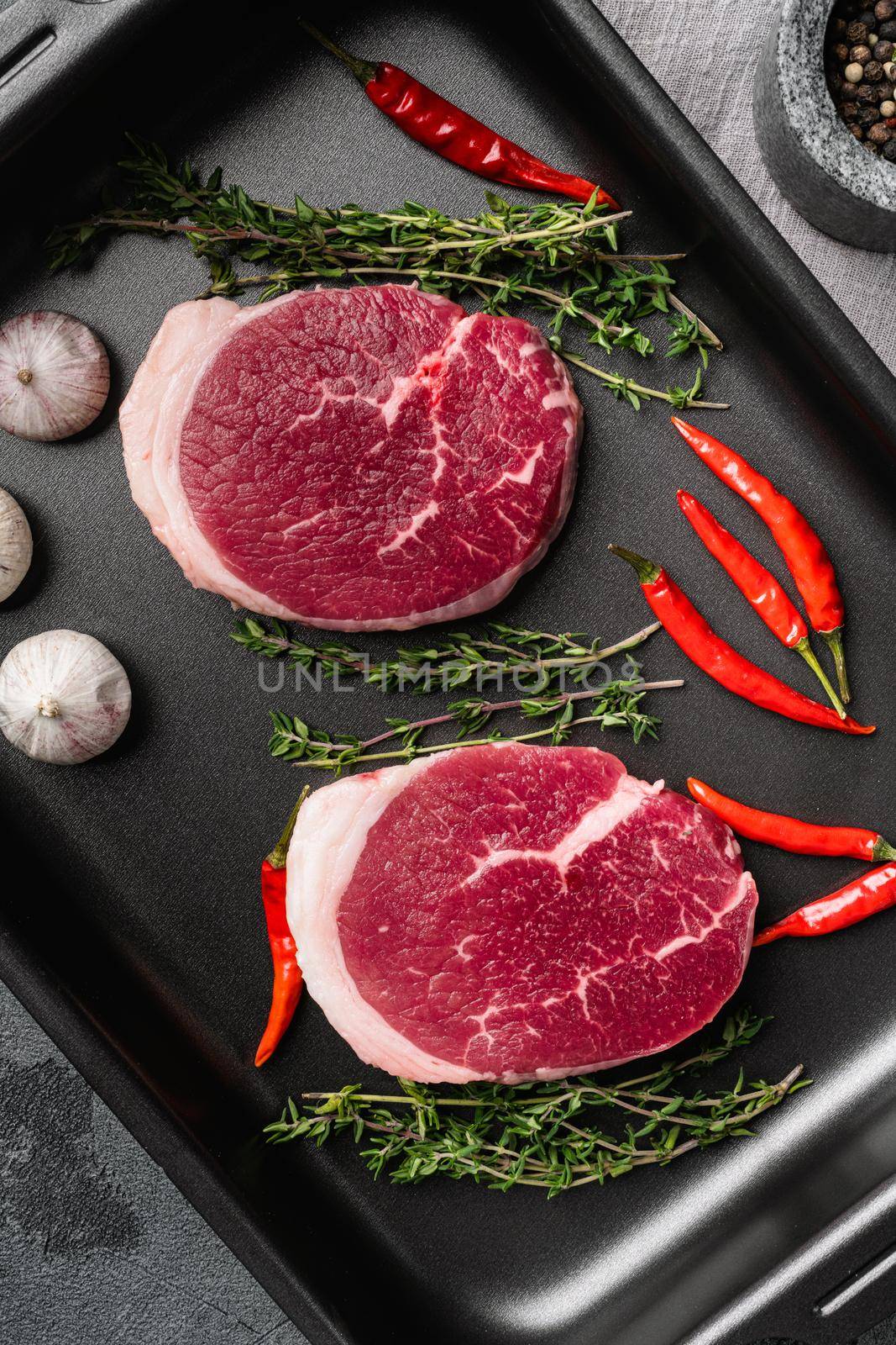 Raw beef meat cut, on gray stone table background, top view flat lay by Ilianesolenyi