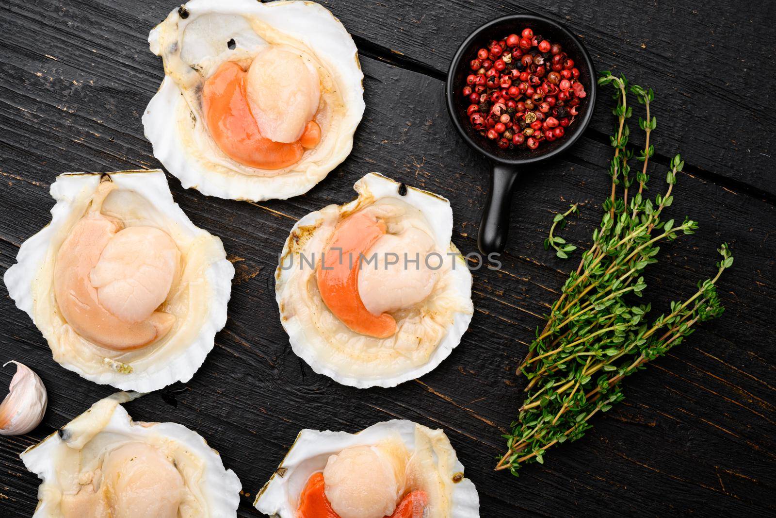 Fresh french scallops seafood market set, on black wooden table background, top view flat lay