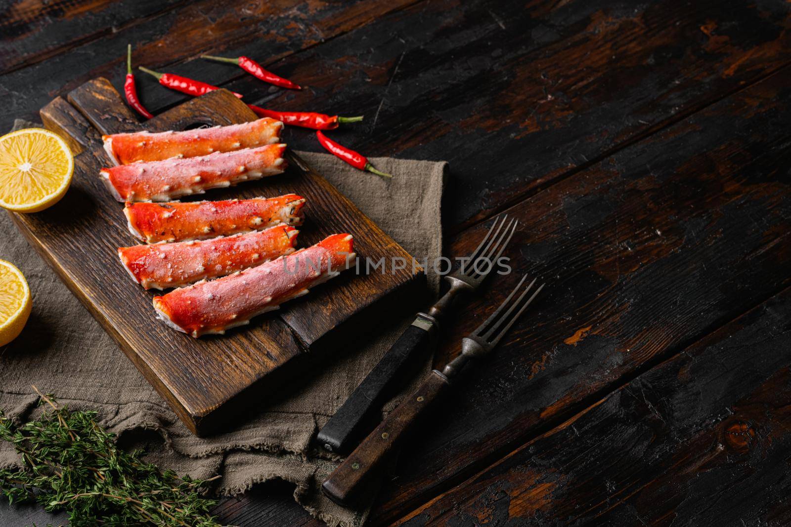 Seafood Crab Legs, on old dark wooden table background, with copy space for text by Ilianesolenyi