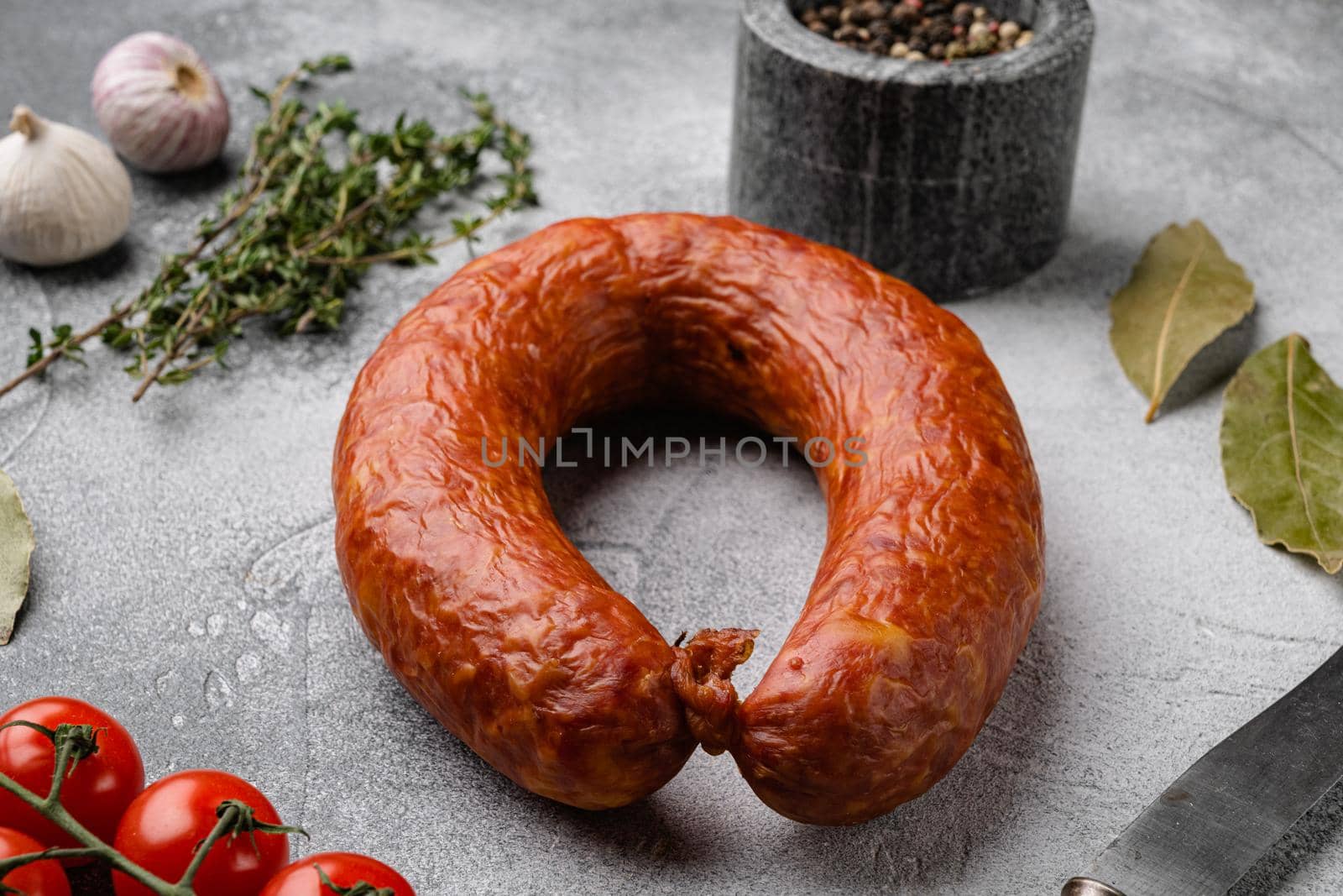 Pork dry cured meat sausage, on gray stone table background by Ilianesolenyi