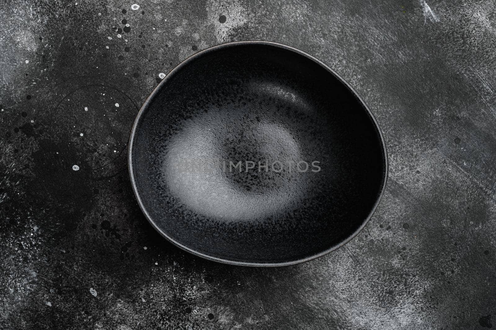 Empty black bowl set, with copy space for text or food, with copy space for text or food, top view flat lay, on black dark stone table background