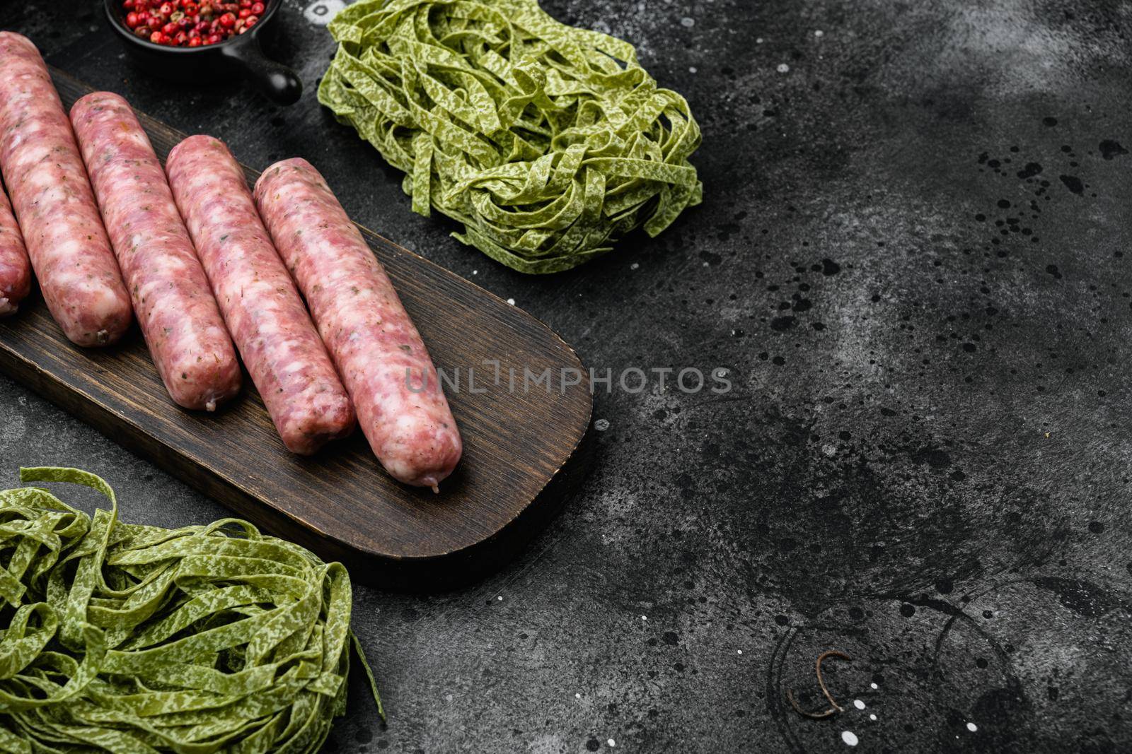 Easy sausage carbonara ingredients set, on black dark stone table background, with copy space for text