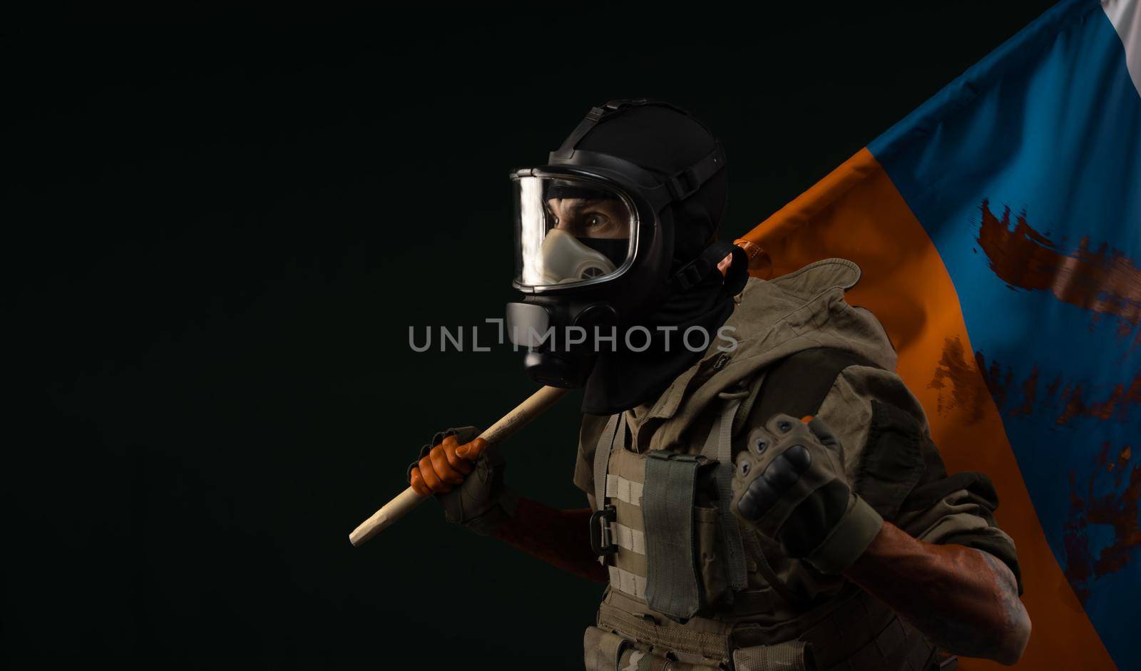 a male soldier in military uniform in a bloody gas mask holds a bloodstained flag of Russia on a black background by Rotozey