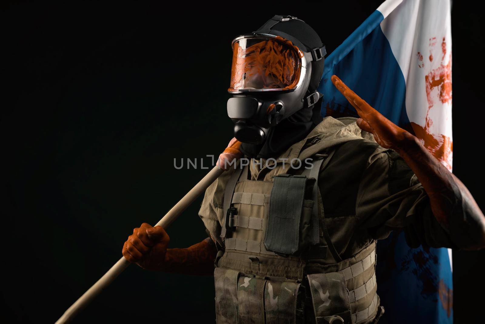 a male soldier in military uniform in a bloody gas mask holds a bloodstained flag of Russia on a black background by Rotozey