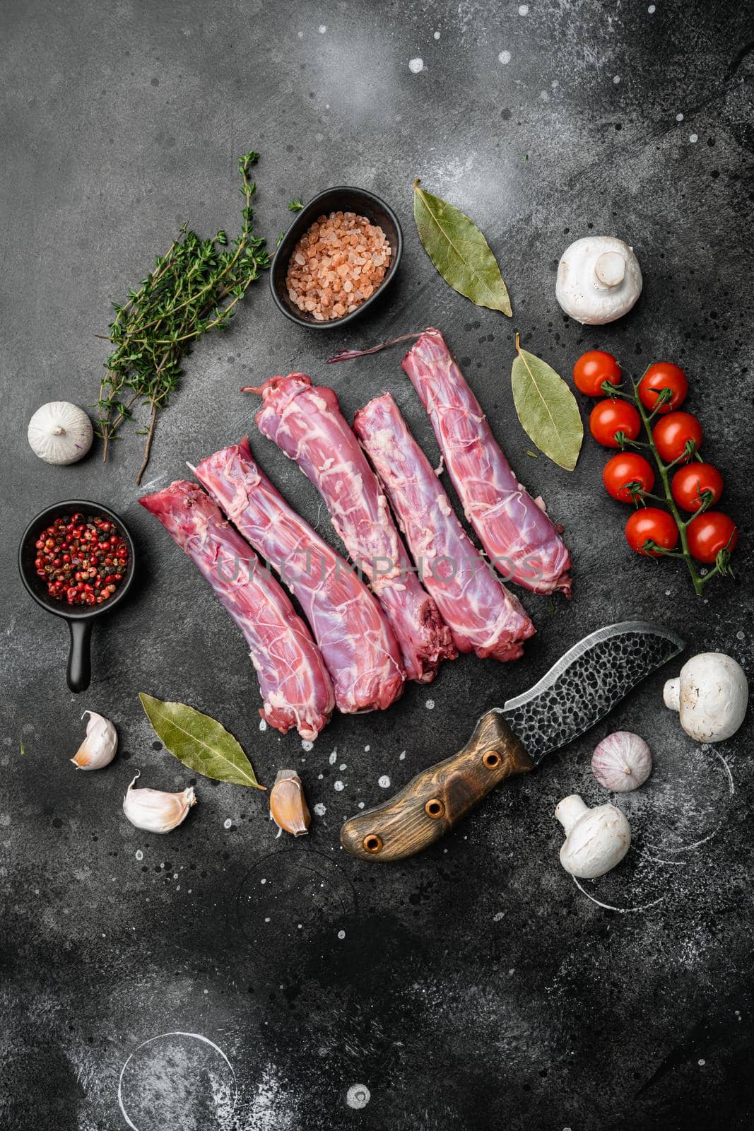 Raw chicken neck, on black dark stone table background, top view flat lay, with copy space for text by Ilianesolenyi