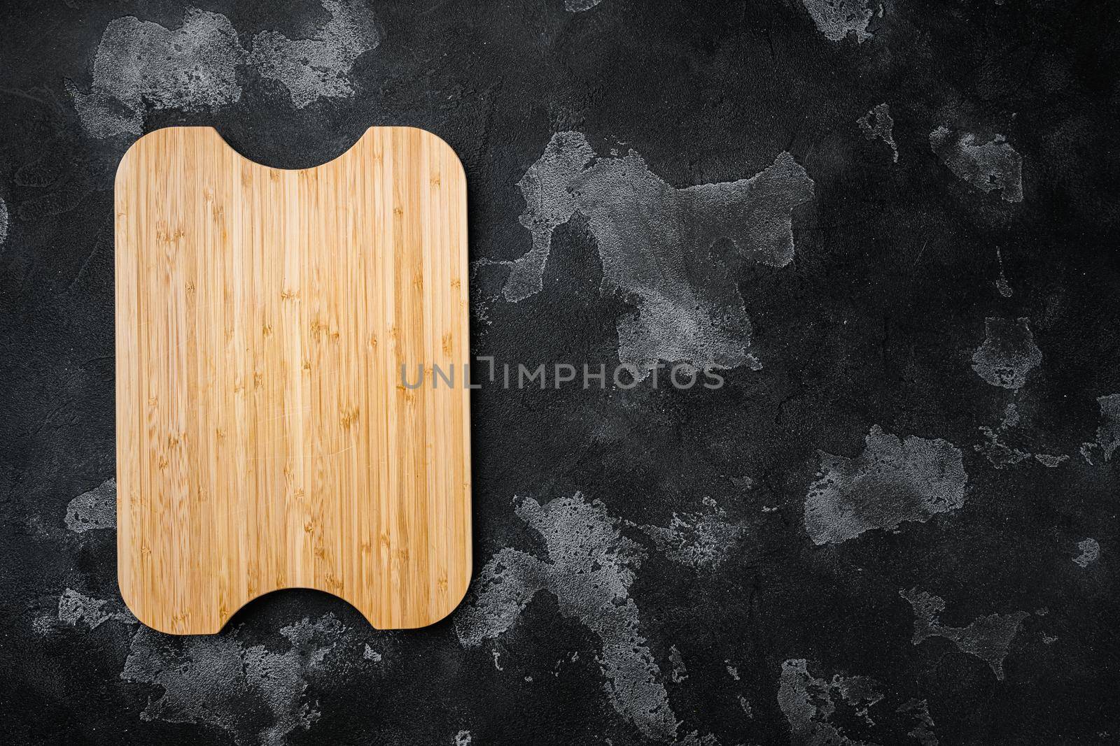 Empty vintage cutting board, on black dark stone table background, top view flat lay , with copy space for text or your product by Ilianesolenyi