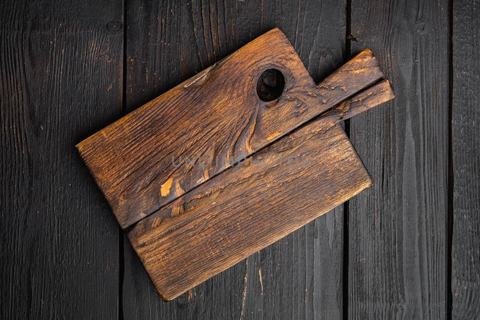 Old wooden kitchen board set, top view flat lay , with copy space for text or food, on black wooden table background