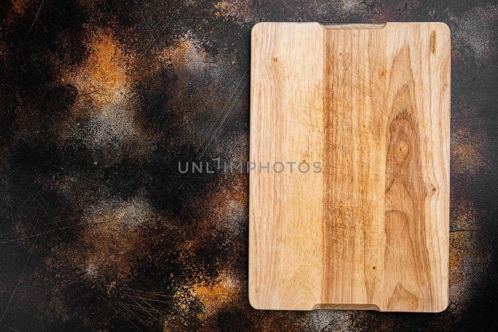 Pine wooden cutting board, on old dark rustic table background, top view flat lay , with copy space for text or your product by Ilianesolenyi