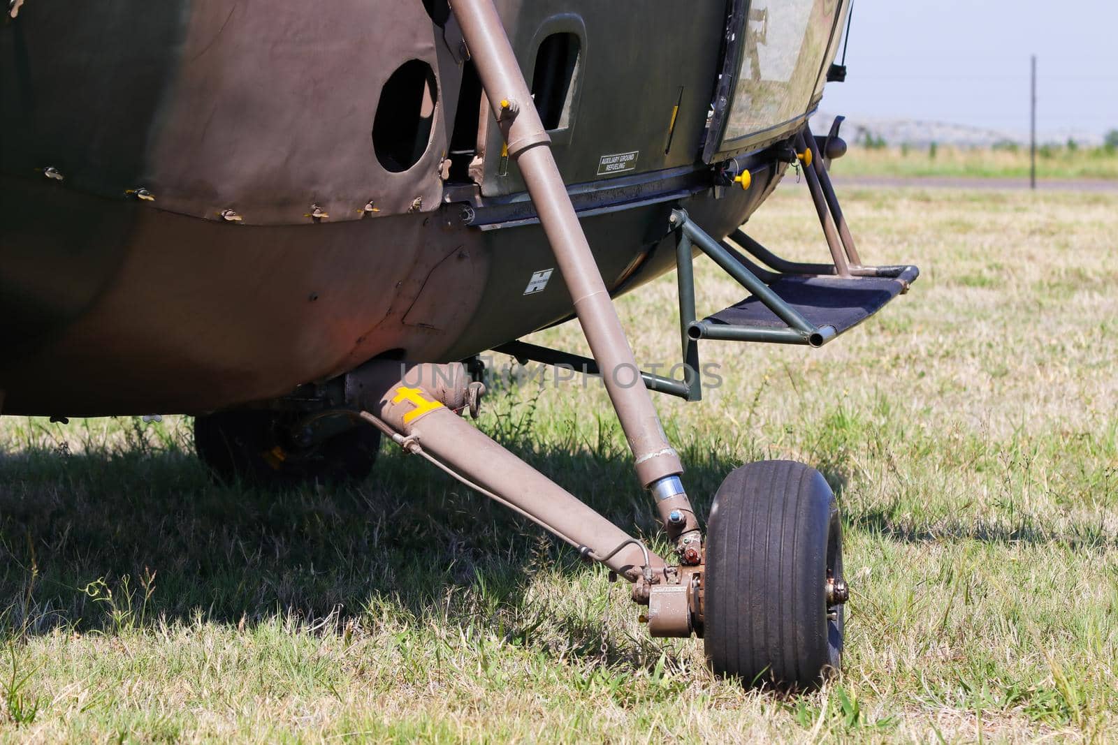 Military Alouette III helicopter landing gear on grass abstract close-up, South Africa