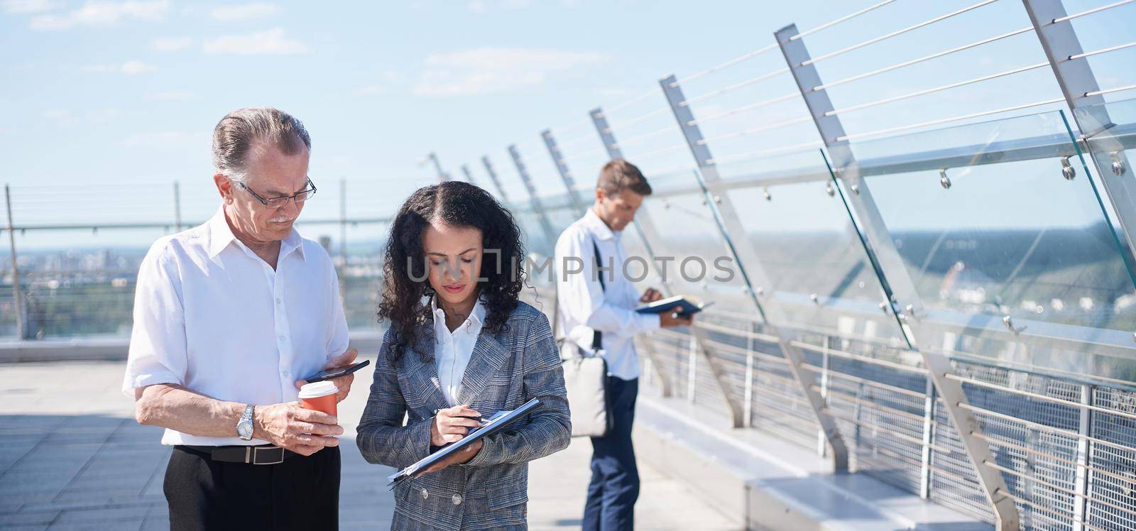 business colleagues discussing a financial document during a coffee break . by SmartPhotoLab