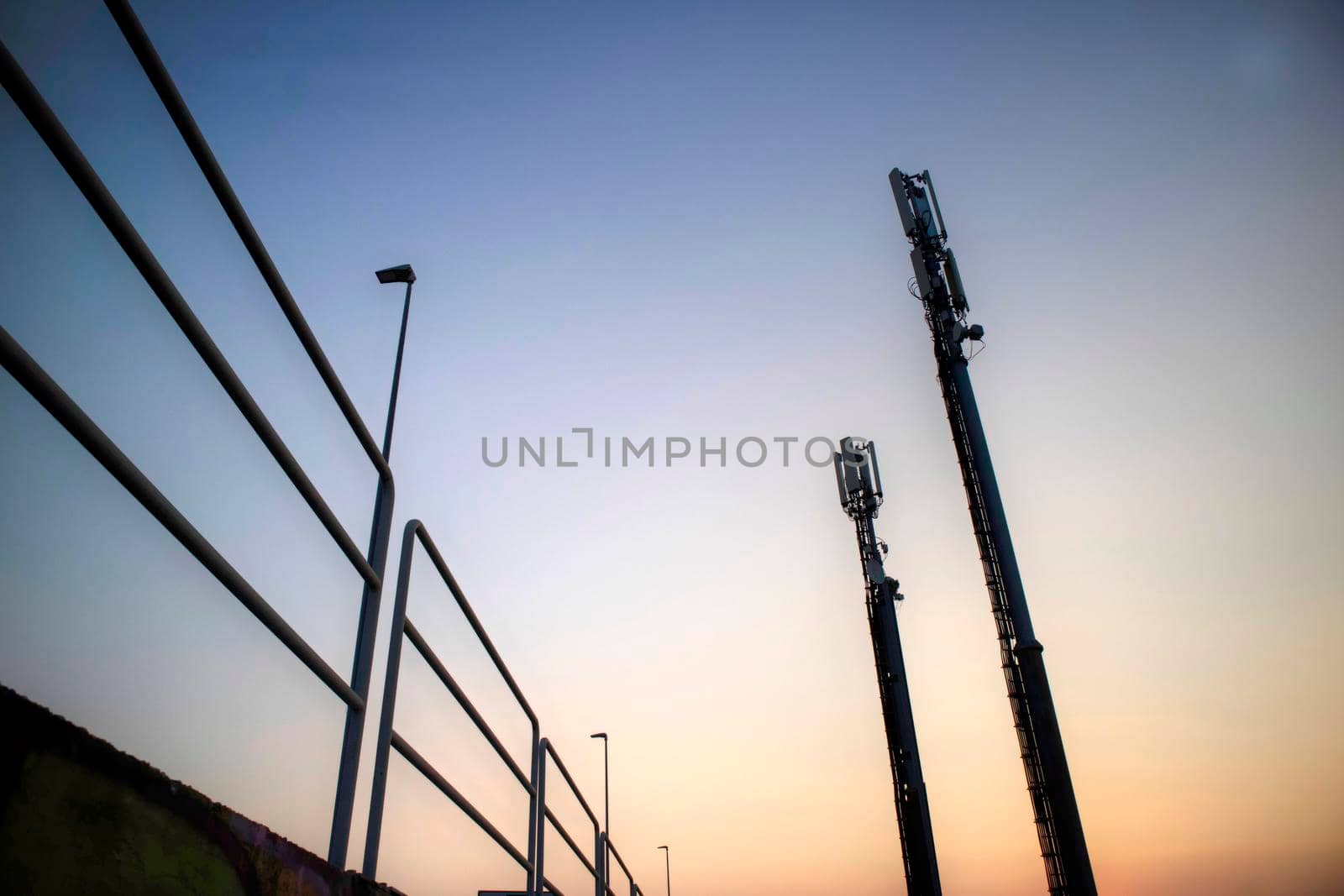 Sunrise photo shoot of mobile phone poles backlit image 