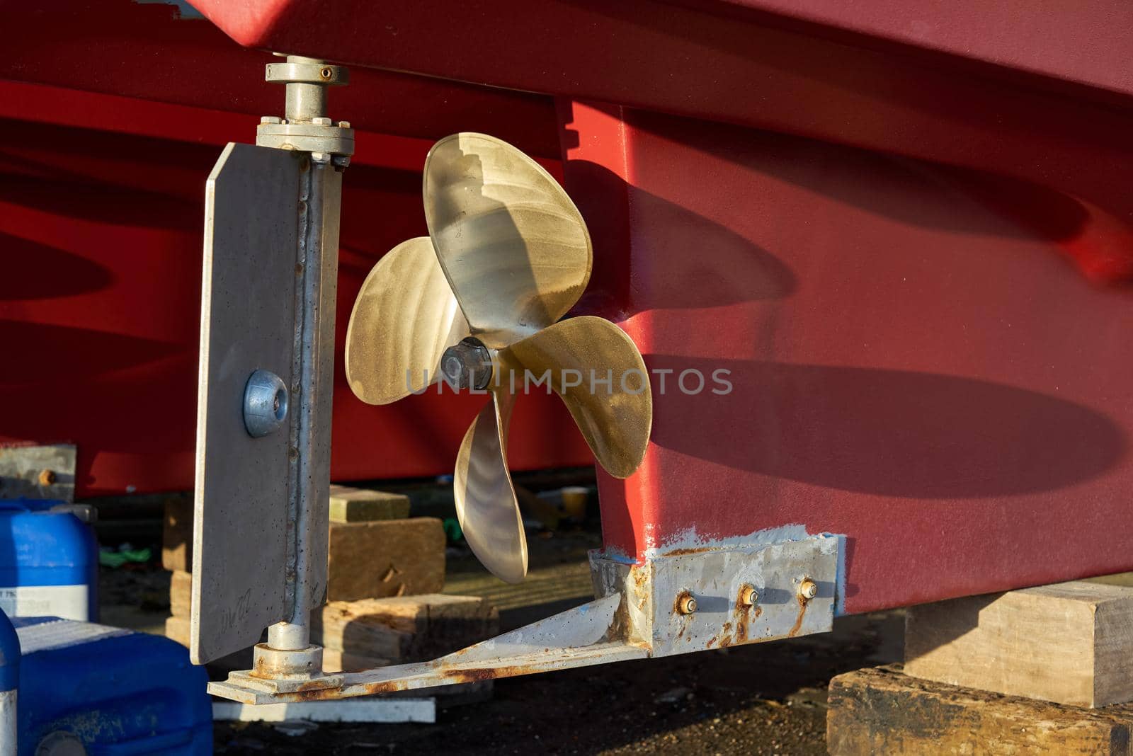 The rudder and propeller of a boat in dry dock by ChrisWestPhoto