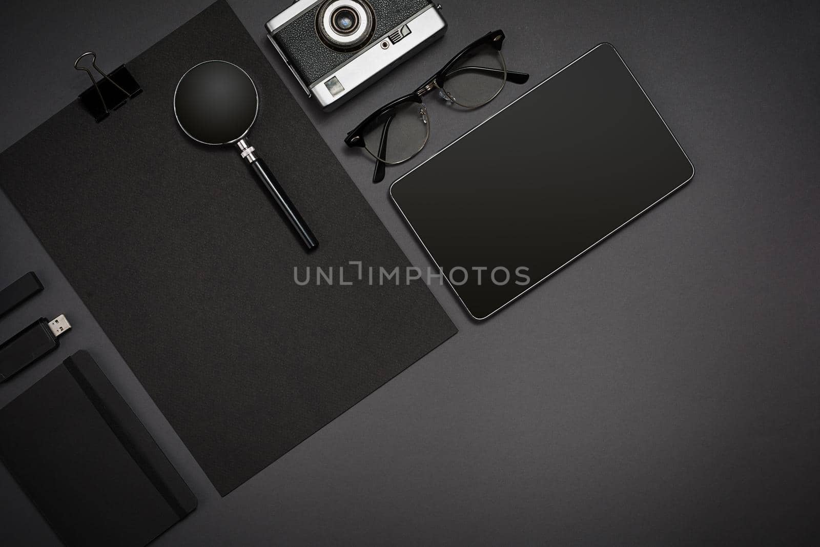 Still life, business, office supplies or education concept : top view image of notepad, mobile phone and coffee cup on black background, ready for adding or mock up