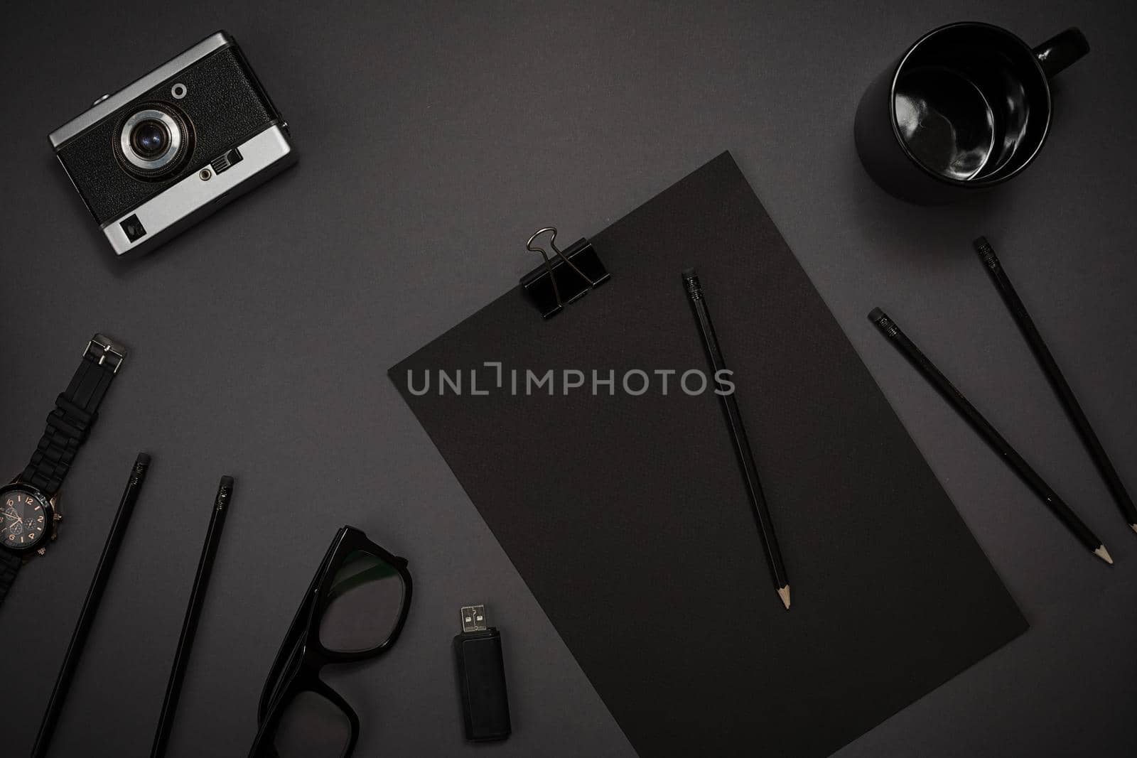 Still life, business, office supplies or education concept : top view image of notepad, mobile phone and coffee cup on black background, ready for adding or mock up