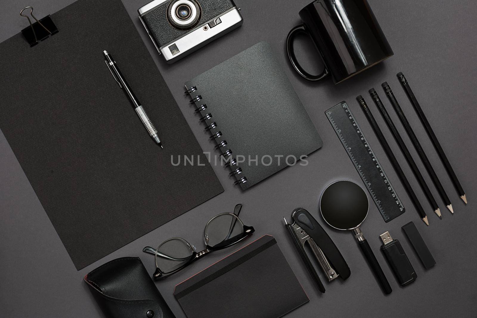 Workplace with office items and business elements on a black background. Concept for branding. Top view. Copy space. Still life