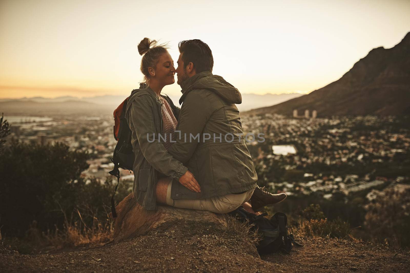 Our idea of romance is adventure. Cropped shot of an affectionate couple on a mountain top. by YuriArcurs