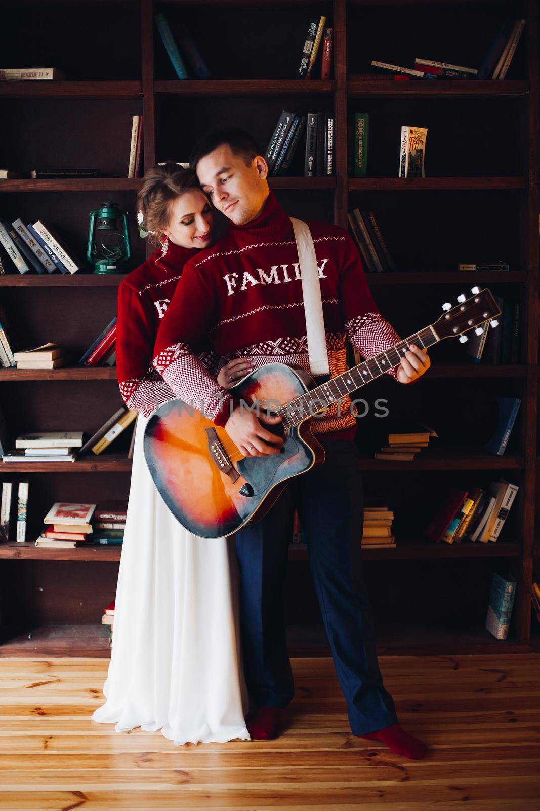 Couple playing on gitar and embracing. by StudioLucky