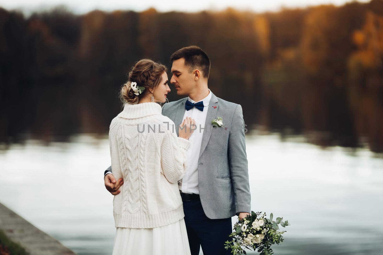 Crop of elegant newlywed against lake surface. by StudioLucky