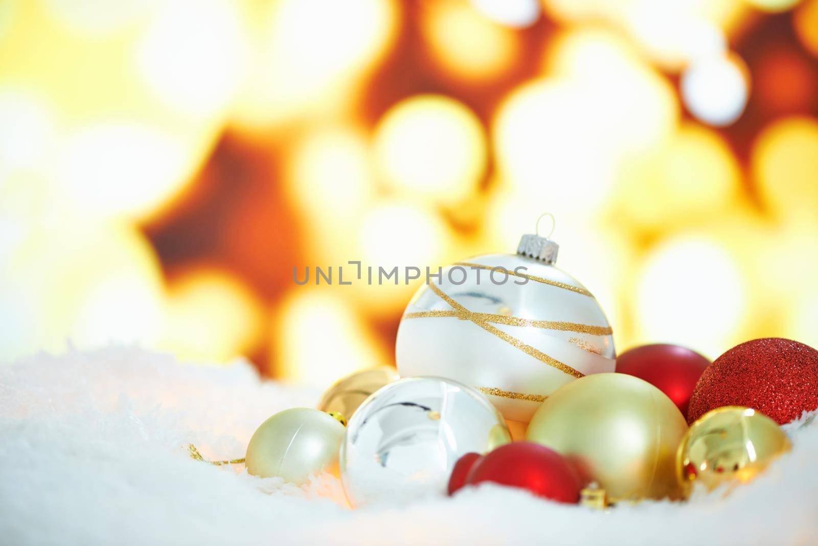 An arrangement of Christmas decorations against a background of lights.
