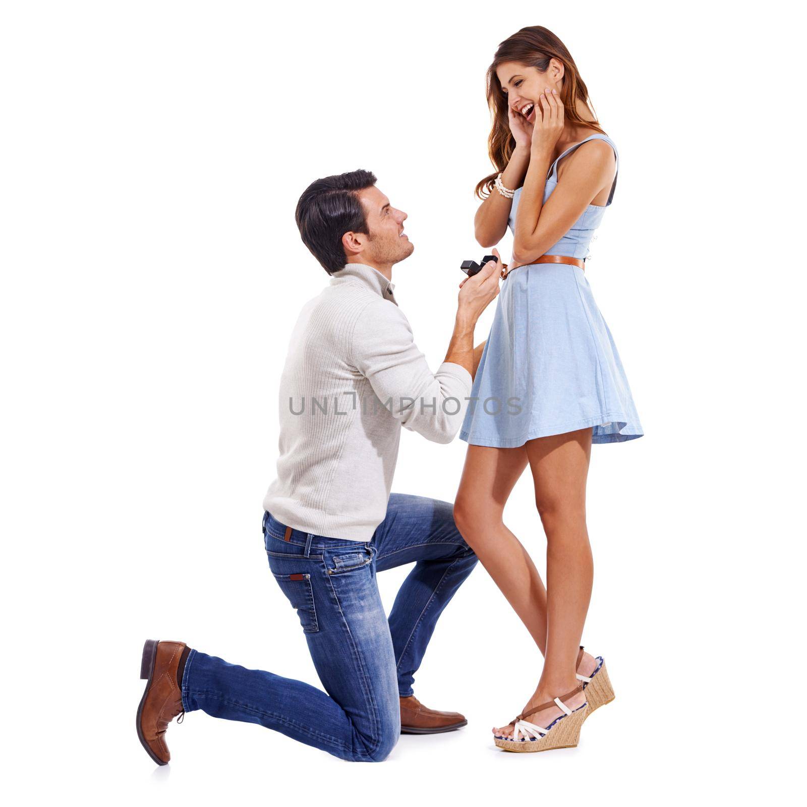 Full-length studio shot of a young couple getting engaged isolated on white.