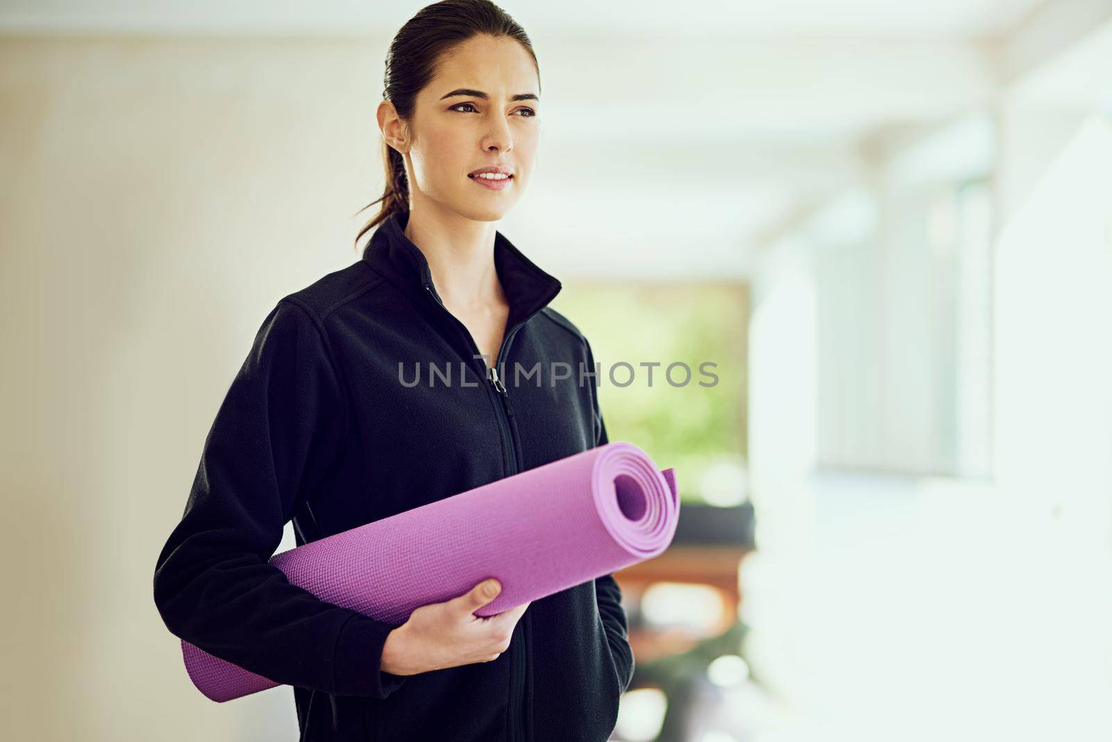 On her way to yoga. Cropped shot of an attractive young woman on her way to yoga. by YuriArcurs