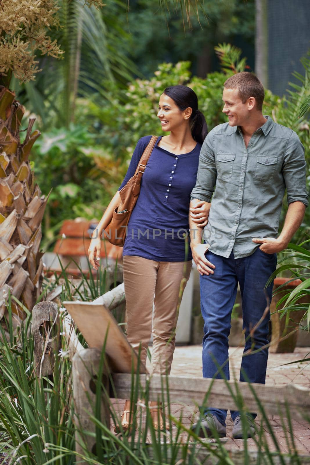 Taking her on a date. Shot of an attractive young couple enjoying a date. by YuriArcurs