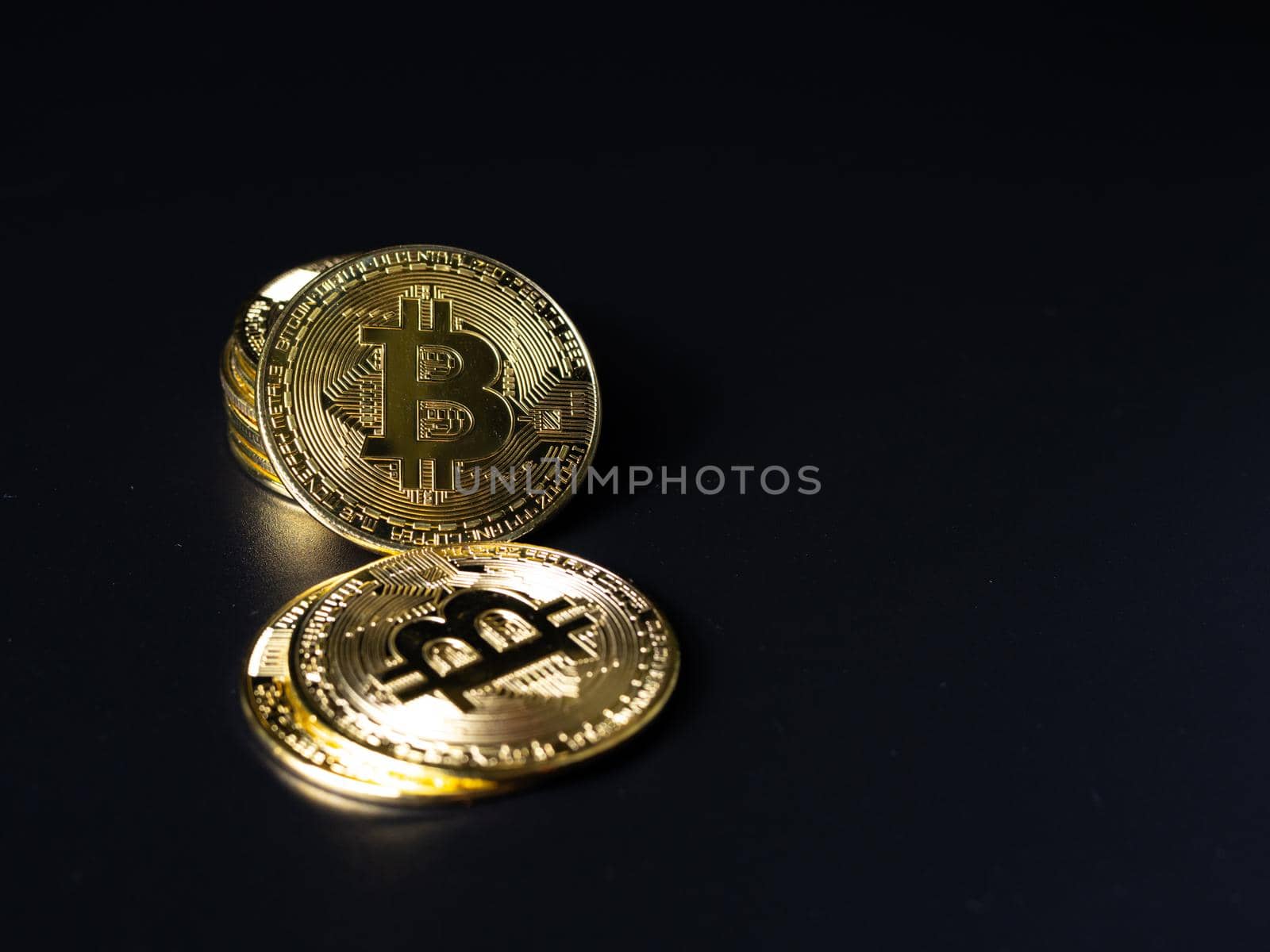Bitcoin Coins as Cryptocurrency placed on a black background by Unimages2527