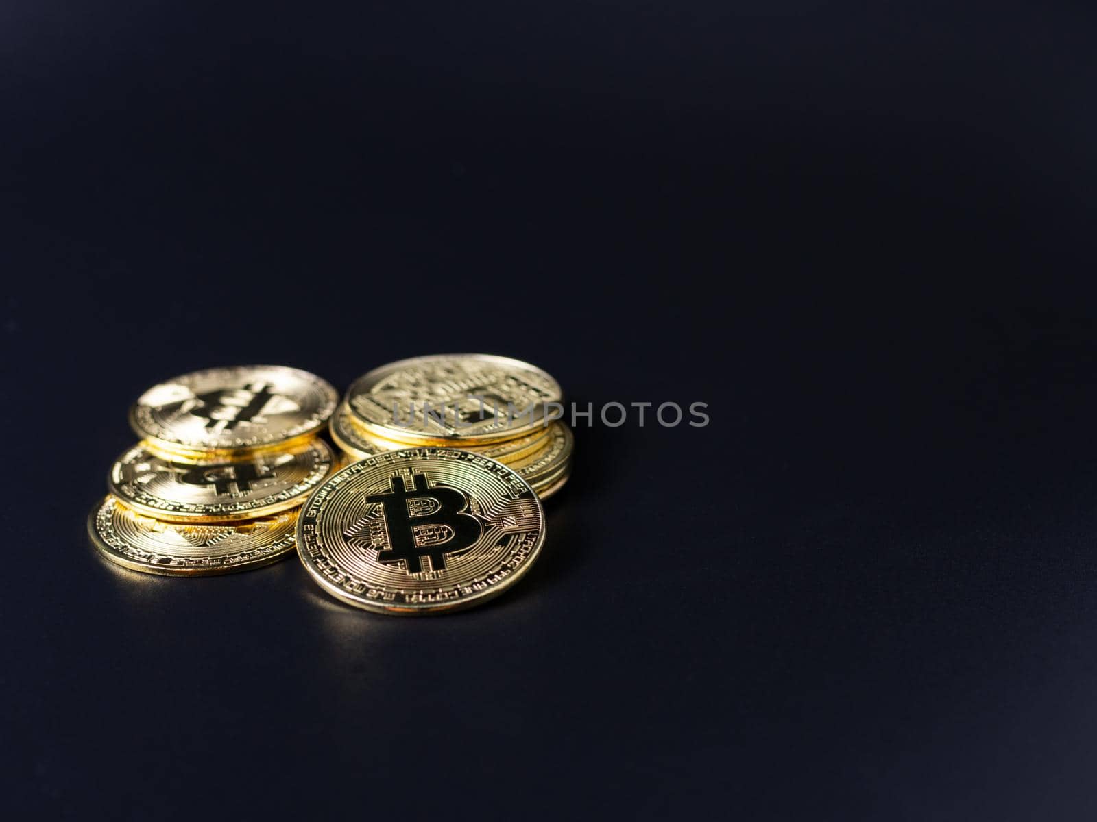 Bitcoin Coins as Cryptocurrency placed on a black background