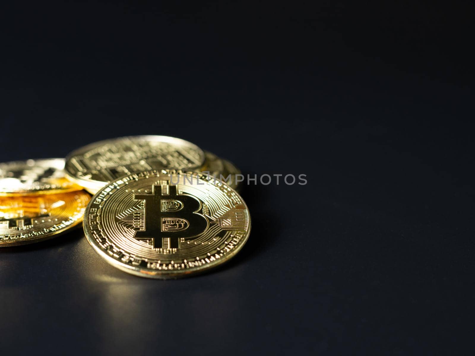 Bitcoin Coins as Cryptocurrency placed on a black background by Unimages2527