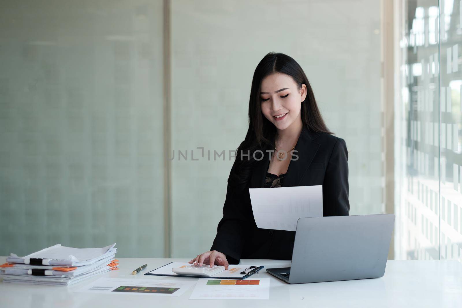 Asian Business Woman or Accountant with paperwork on desk, account, audit and saving concept